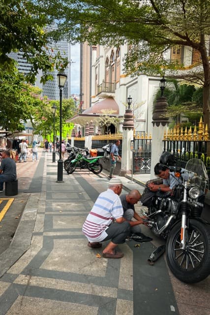 Fixing a motorbike in Little India, Singapore (2023)